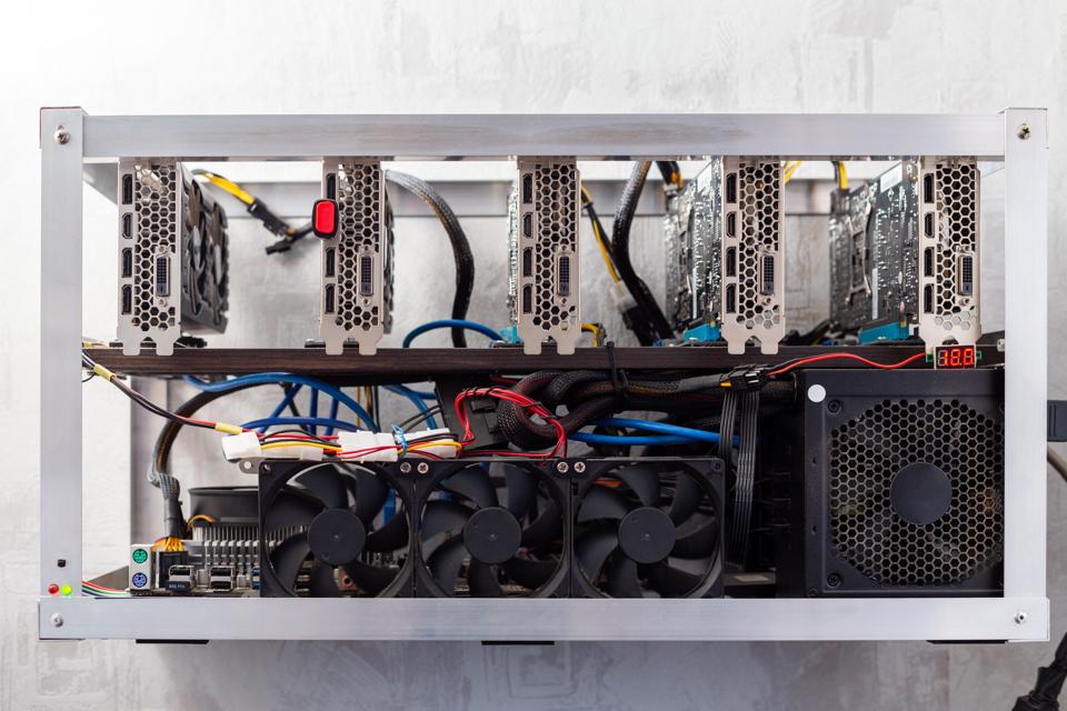 domestic gpu cripto mining rig on wall with selective focus