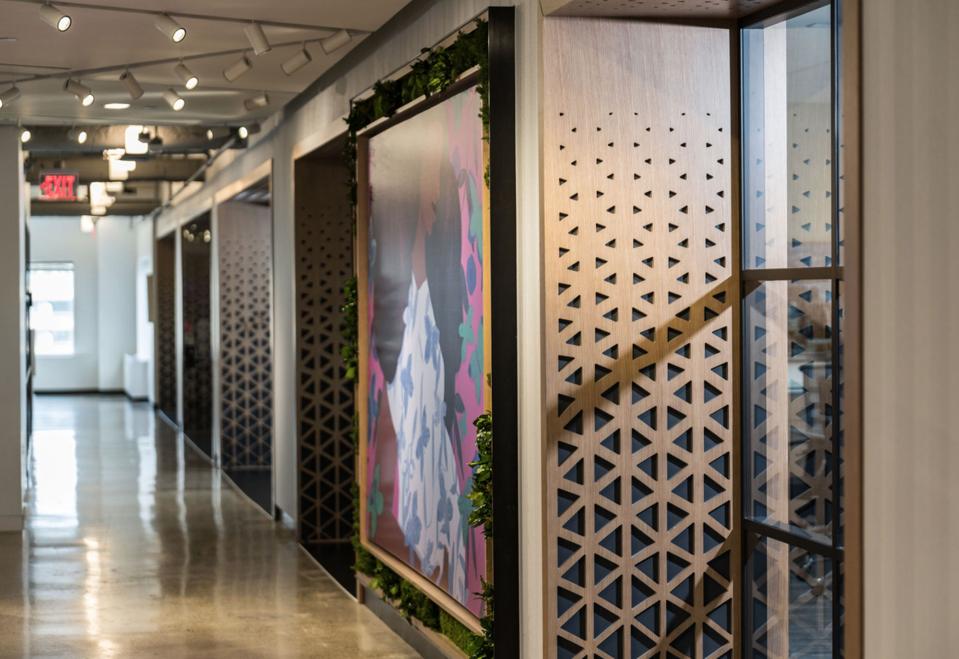 ″One of the first features you see is the wood lattice that surrounds the conference rooms down to the executive area. Stacey chose the pattern. It points to the unity and dynamics of sharp lines coming together to create something beautiful.″ - Gavin Daniels