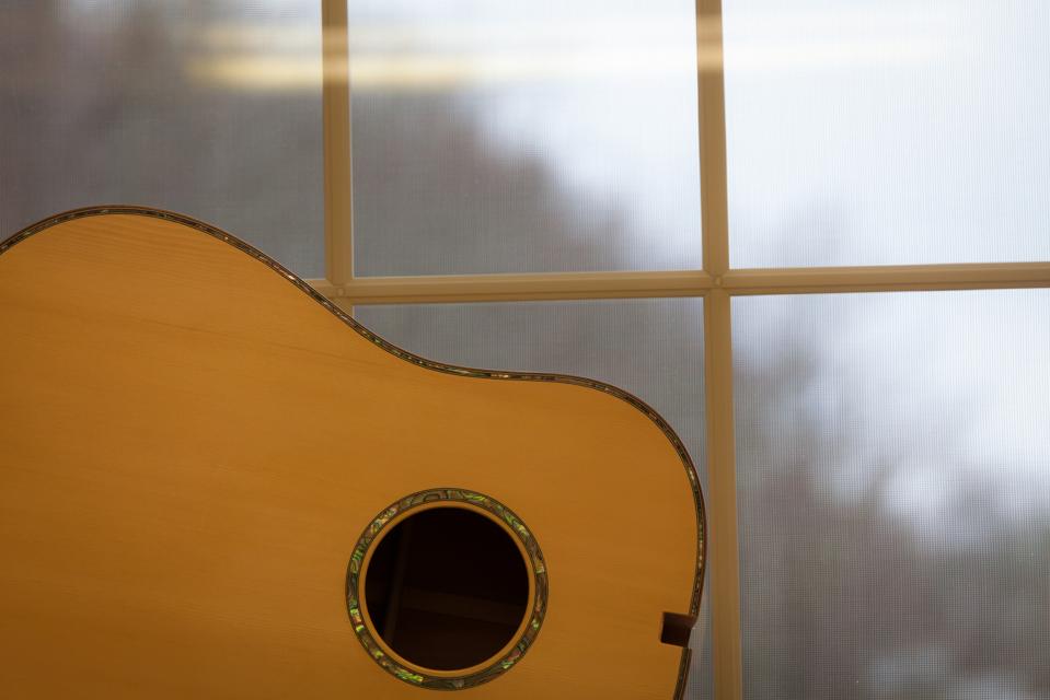 Guitar sits in a window in Appalachia.