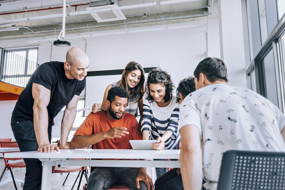 A group of young people working together in an office.