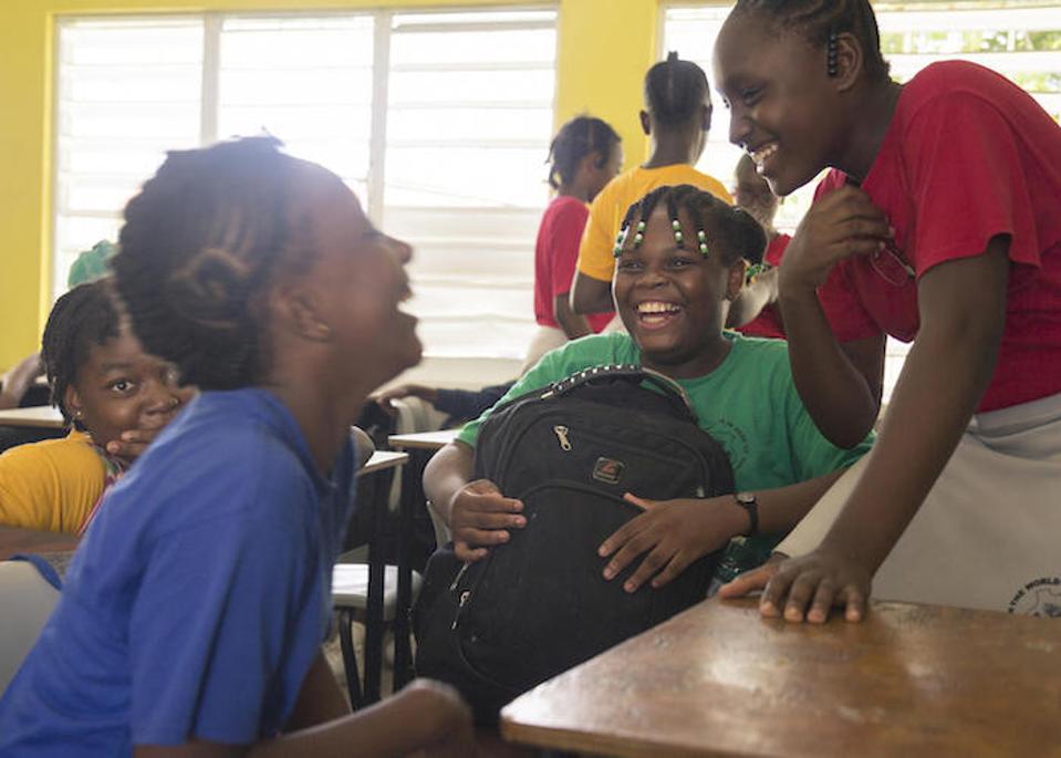 Eleven-year-old Jerrene (center) shares a laugh with fellow students at Princess Margaret Secondary School in St. John's, Antigua. Jerrene and her brother and mother remained in Antigua because there were better education opportunities there.