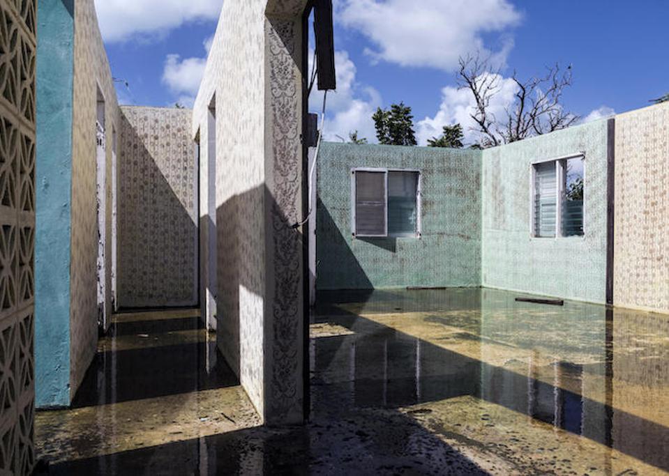 Homes destroyed by Hurricane Irma in 2017 stand empty on the island of Barbuda. A majority of people who evacuated following the storm have returned, but many homes remain unrepairable or unlivable.