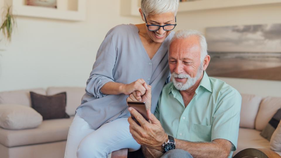 Senior couple using mobile phone