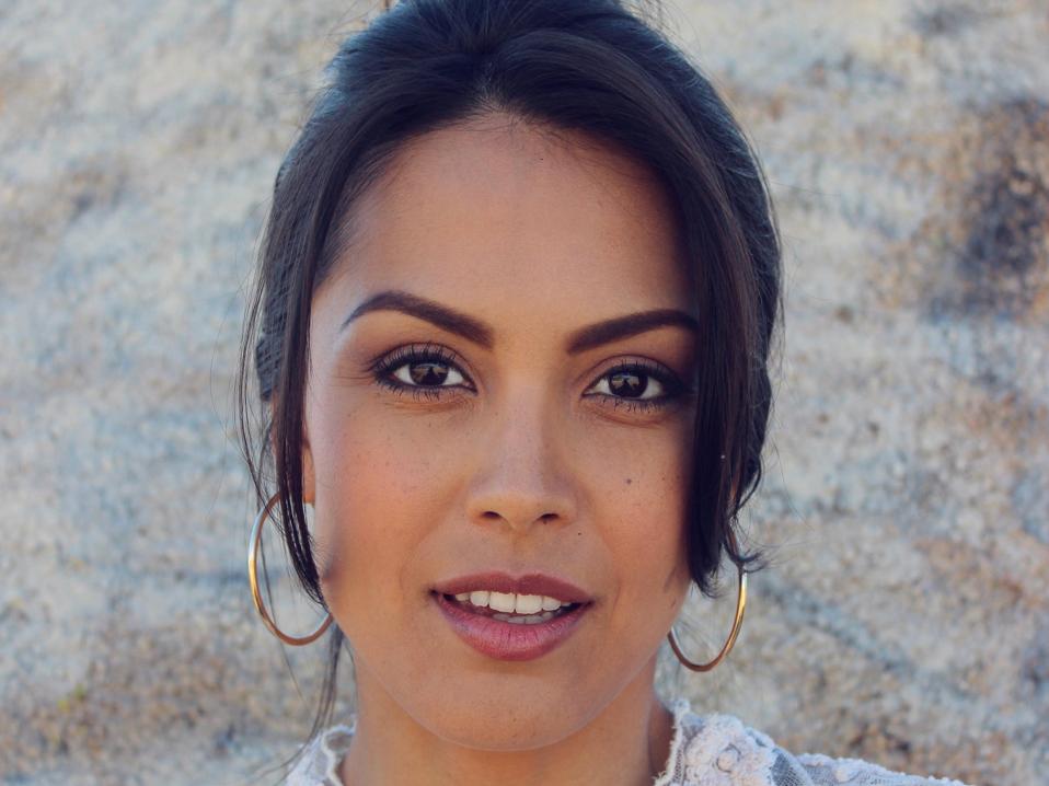 Headshot of Pomplun in a lace top.