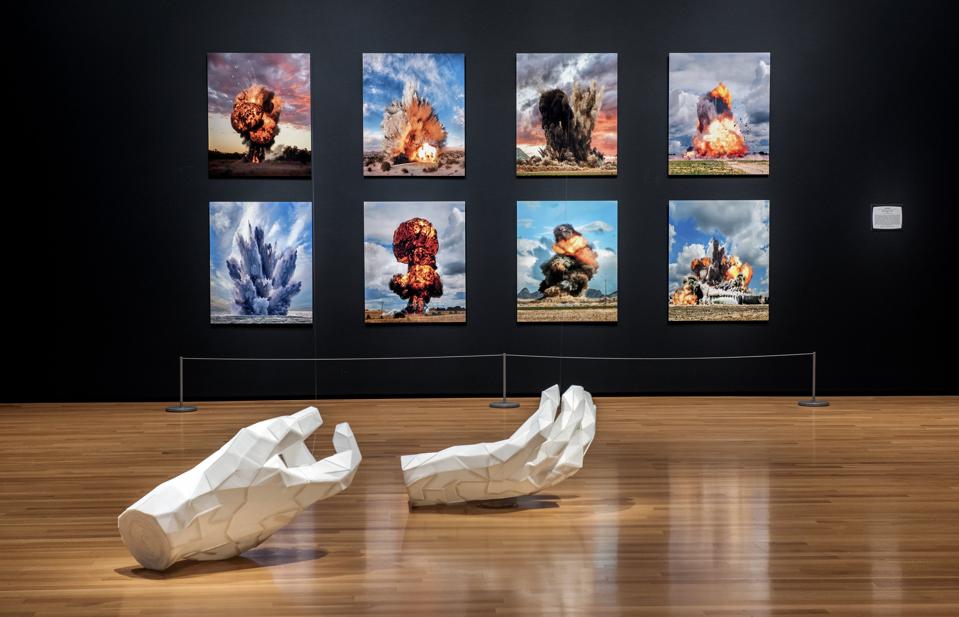 “Open World: Video Games & Contemporary Art” installation view at Akron Art Musuem.
Foreground: Joseph DeLappe, Taliban Hands, 2011, corrugated plastic, 28 x 14 x 40 in. Each, courtesy of the artist; background: Ueli Alder, Untitled Detonations #1–#8, 2011, inkjet prints, 37.8 x 31.5 in. each, collection of Fred and Laura Ruth Bidwell.