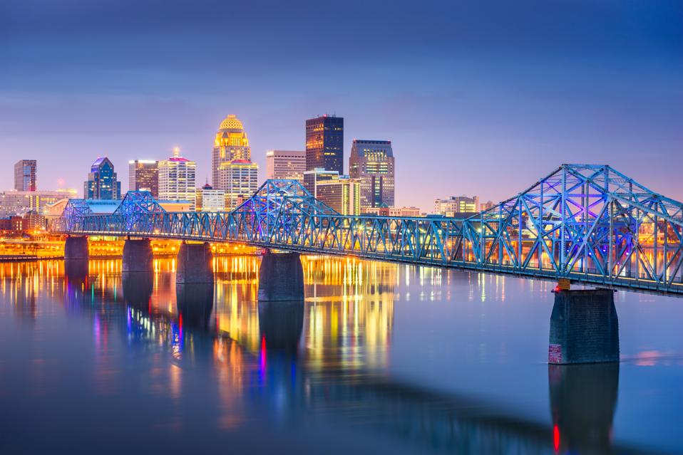 Louisville, Kentucky, USA downtown skyline on the Ohio River at dusk.