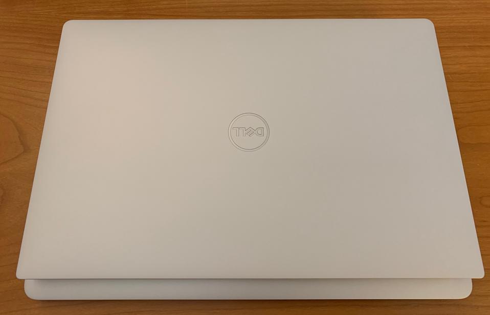 Dell XPS 13 on top and Retina MacBook Air on bottom. The XPS 13 is smaller and slightly lighter than the MacBook Air.