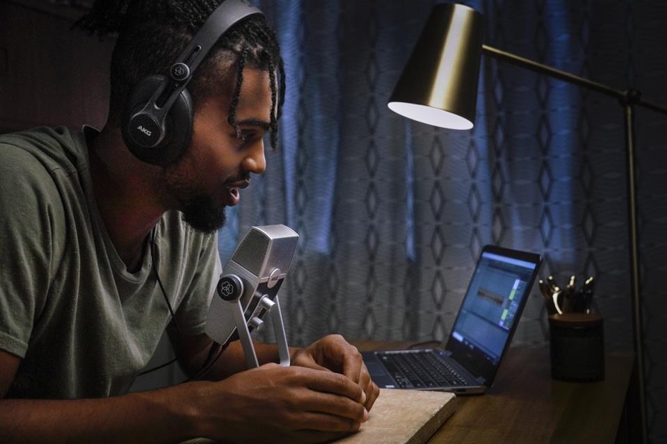 Man talking into AKG Lyra sitting at a desk Man talking into AKG Lyra sitting at a desk