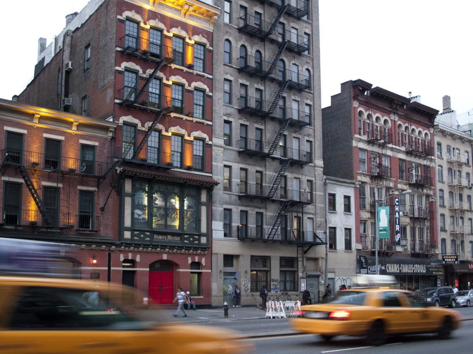 Taxi cabs driving along the Bowery, Manhattan, New York City