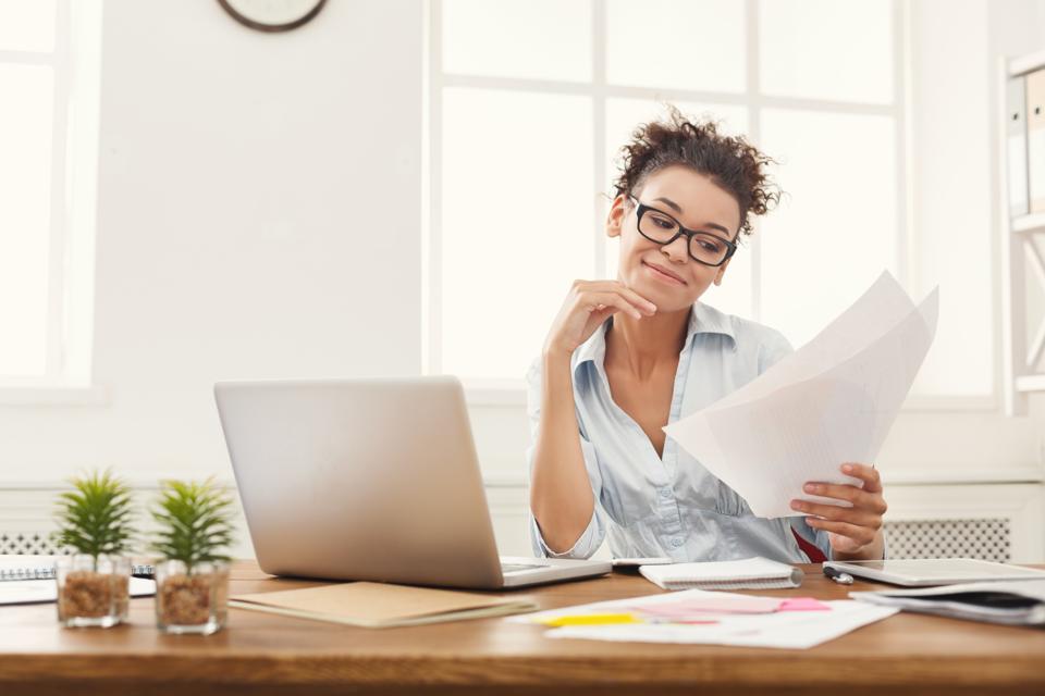 Woman reading documents searching for job.