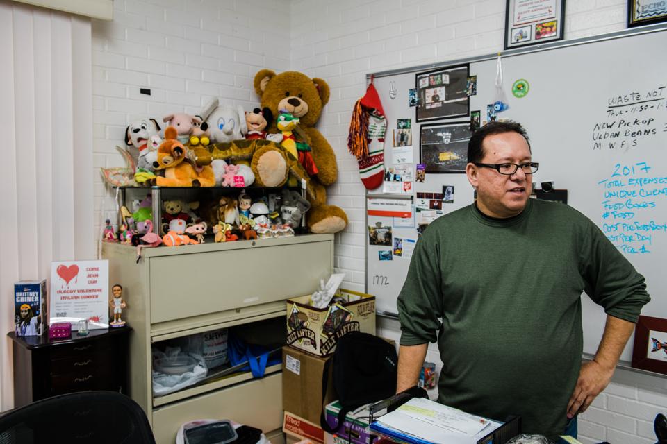 Joseph Gaxiola in his office at the Joshua Tree Feeding Program — a food pantry for the HIV positive community in Phoenix — where he volunteers as chairman.