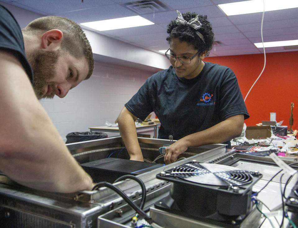 Mike Rudisill (left) and Carina Vargas (right) are part of a rapidly growing Quantum Signal AI team prototyping advanced hardware and using advanced simulations to help Ford develop self-driving vehicles.