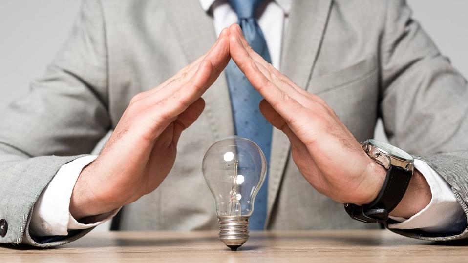 protection gesture above light bulb