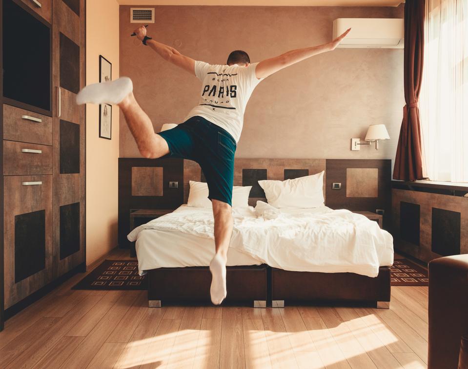 Man jumps onto his bed