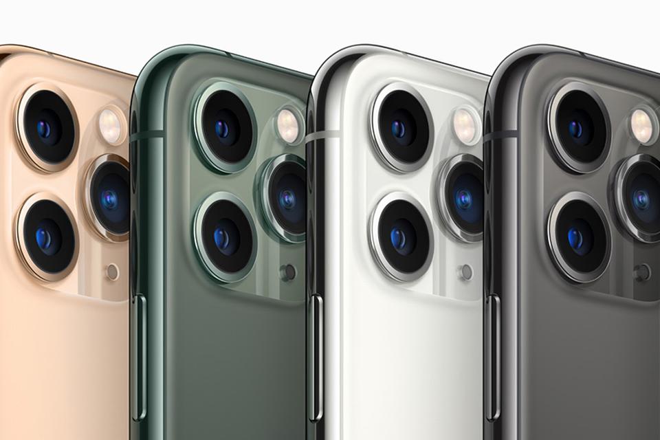 A row of iPhone 11 smartphones in various colors, showing triple rear camera.