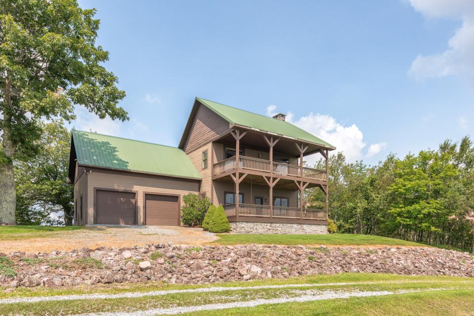 Cabin 2 has four bedrooms, a stone fireplace and full-length porches on two levels.