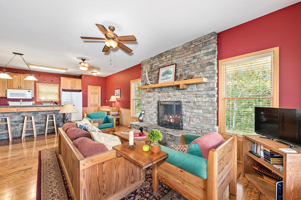 Cabin 2's living space with stone fireplace and kitchen island.