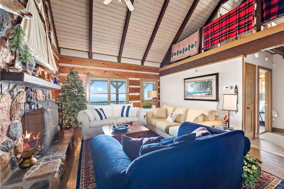 Cabin 3 mixes contemporary materials with traditional features like stone fireplaces and wood floors.