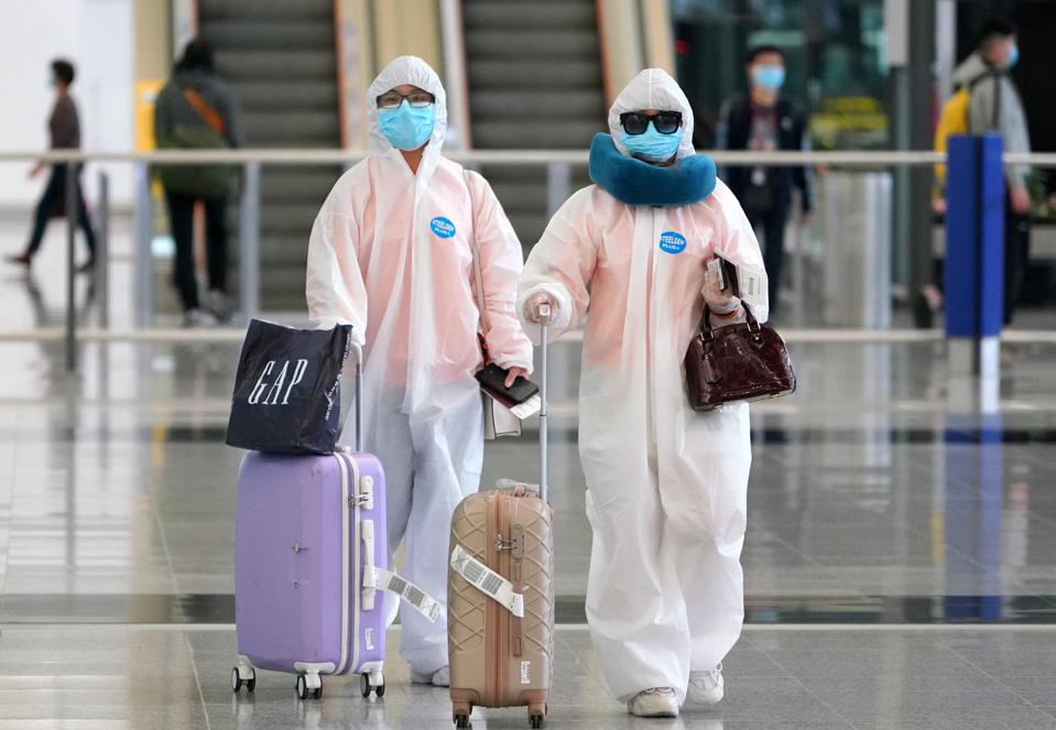 Passengers wearing protective suits.