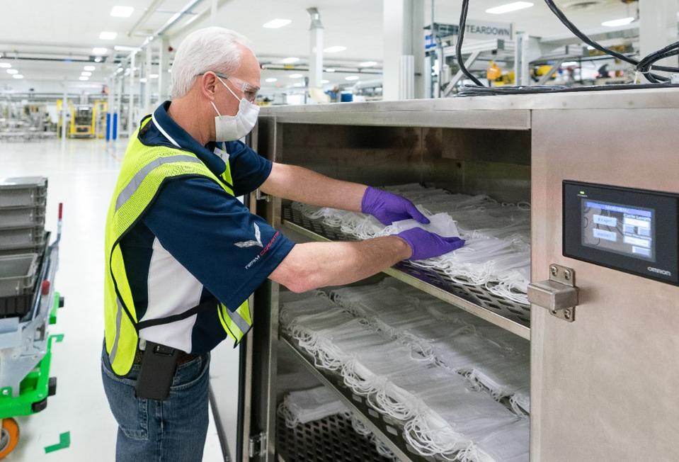 Engineers and technicians set-up and test the machines that will be used to manufacture Level 1 face masks Monday, March 30, 2020 at the General Motors Warren, Michigan manufacturing facility. Production will begin next week and within two weeks ramp up to 50,000 masks per day, with the potential to increase to 100,000 per day. (Photo by John F. Martin for General Motors)