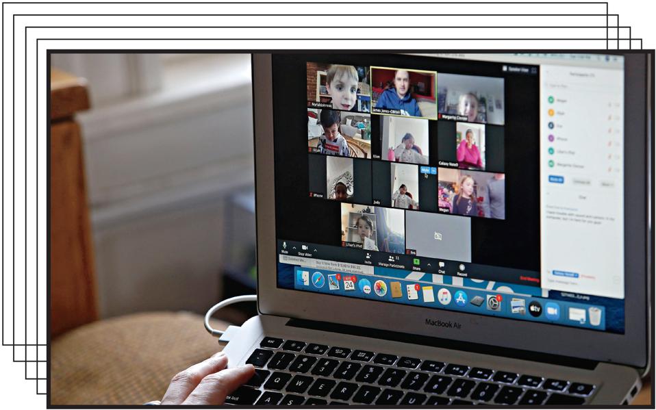 Kindergarten students listen to teacher James Baldwin read a children’s book over Zoom.