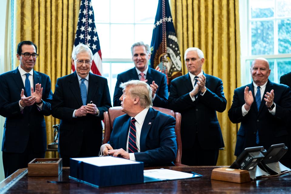 President Trump Signs Coronavirus Stimulus Bill In The Oval Office
