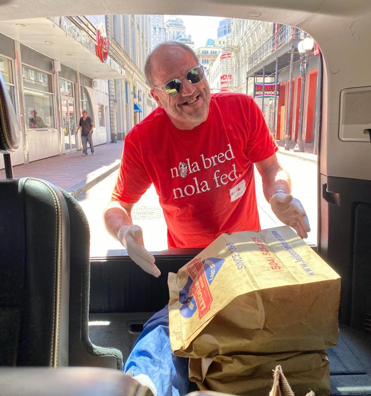 Ralph Brennan loads meals into a car