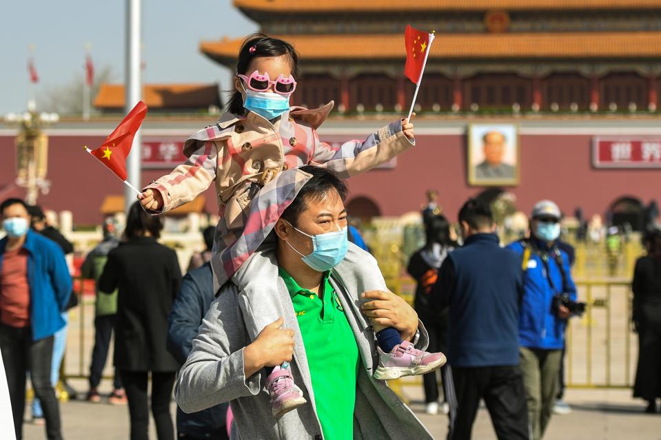 People walking through Tiananmen Square.