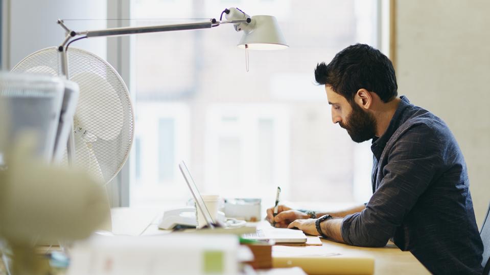 Man writing at desk