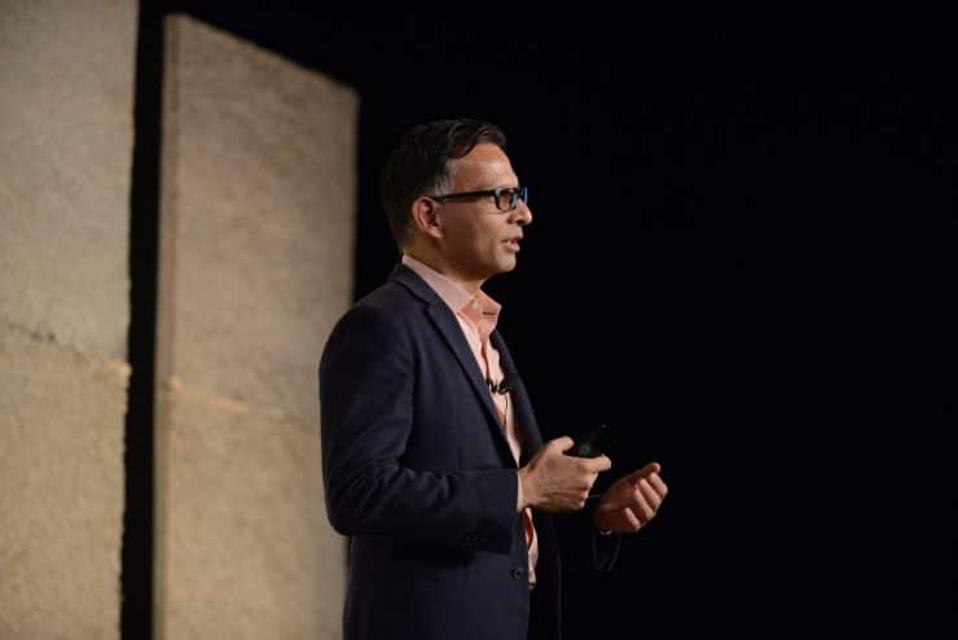 A man speaks at a conference