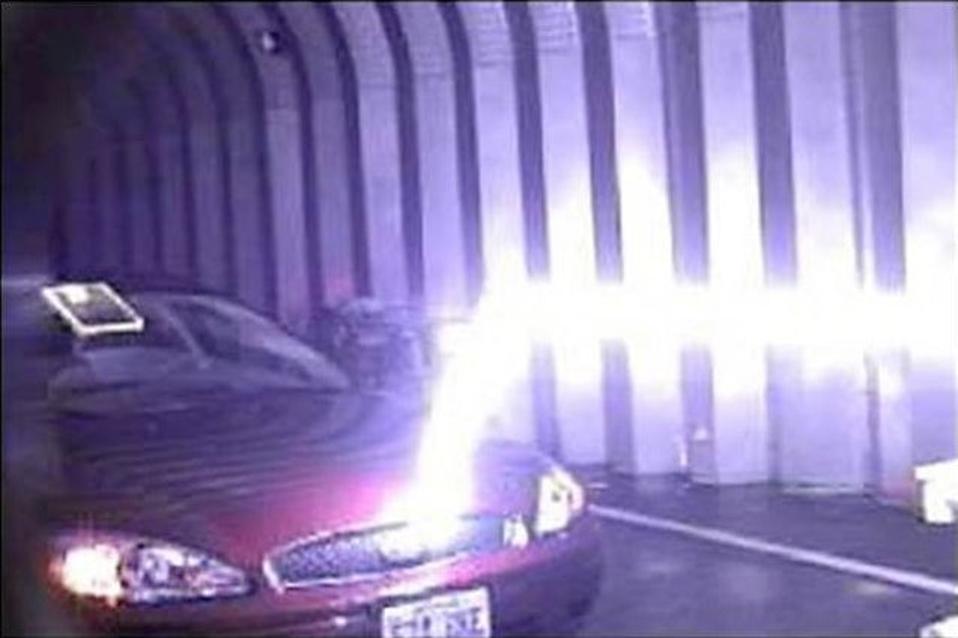 A bolt of artificial lightning striking a car in a laboratory