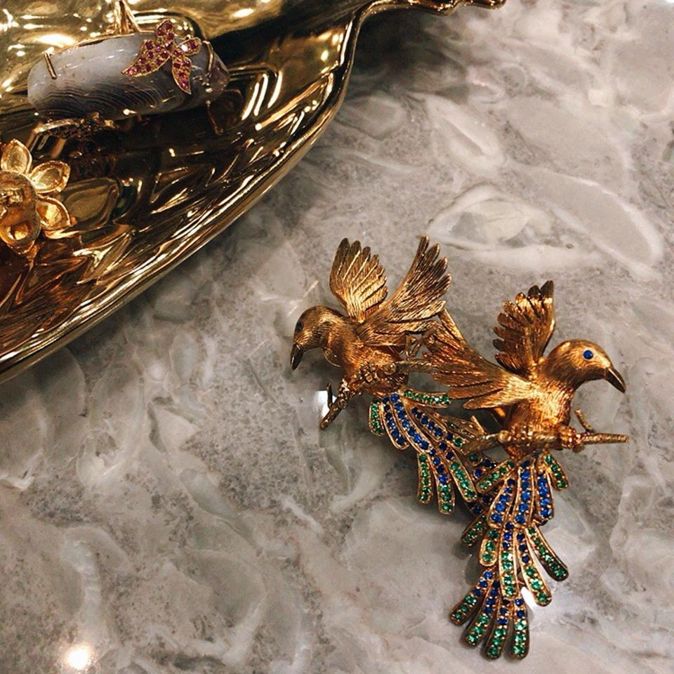 Winged creatures earrings with emeralds and blue sapphires by Tim Tam Ong