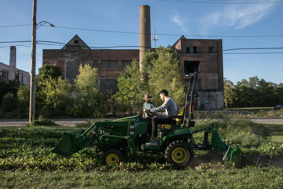 Dan Miller riding a tractor in Detroit.