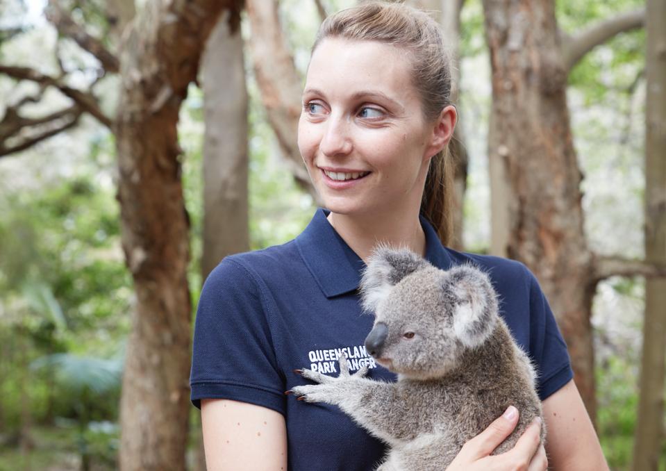 Candice Dixon holding a koala at Currumbin Wildlife Sanctuary in Australia
