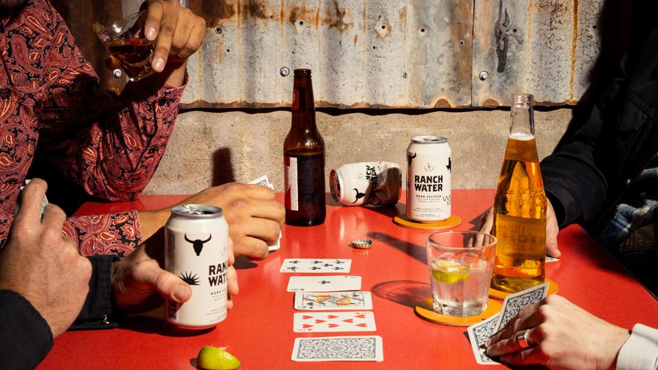 lone river ranch water on table with beers and people