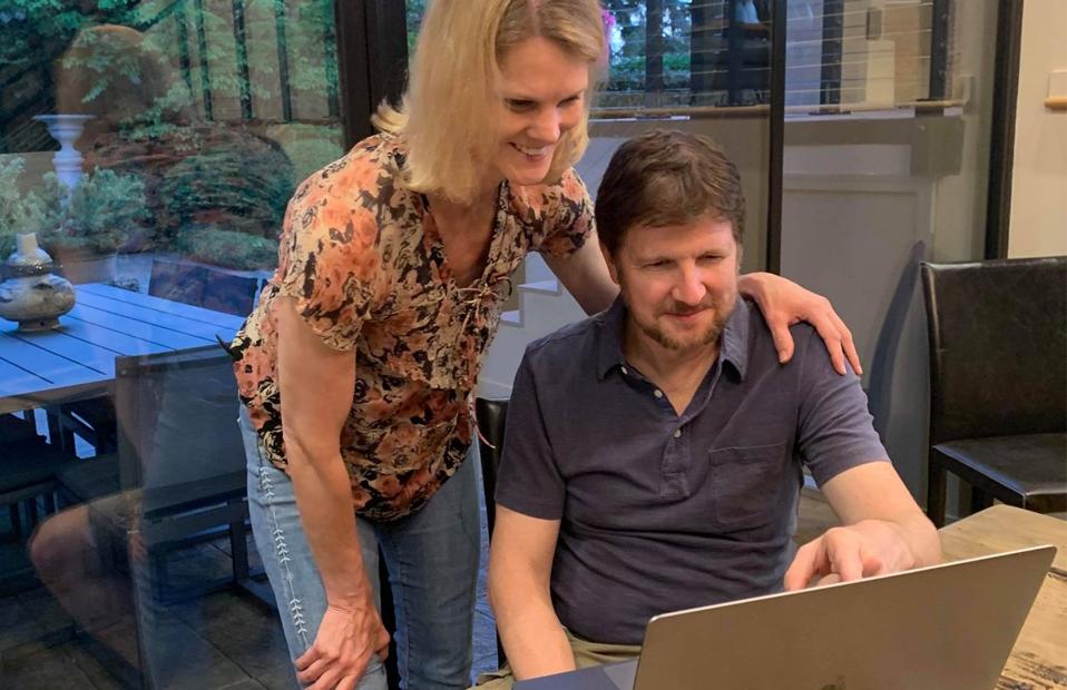 Brad and Debra Aho Willamson at a computer