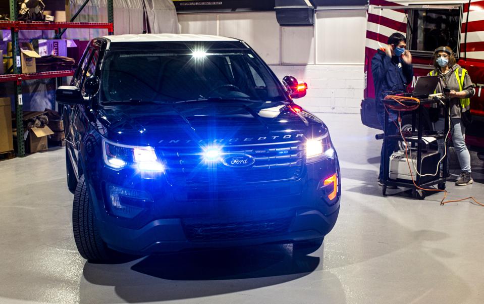 Ford engineers testing a coronavirus heat soak system on a Police Interceptor Utility