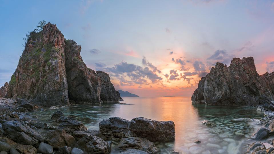 Big rock at sea coast in morning sunlight