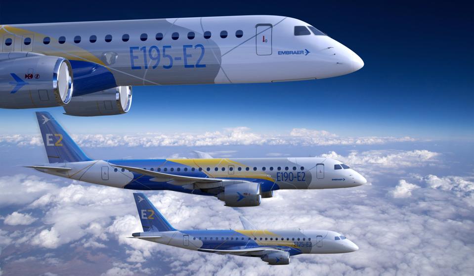 Three Embraer-branded E2 medium-range jets, flying side-by-side.