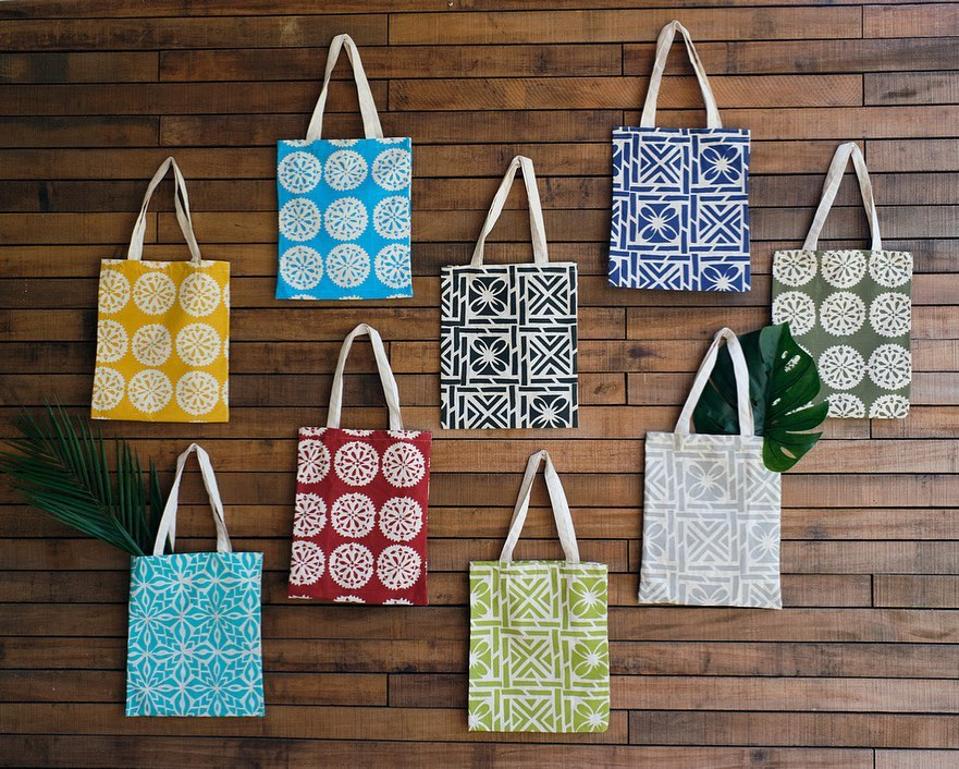 Eight different tote bags for sale from Rise Beyond the Reef