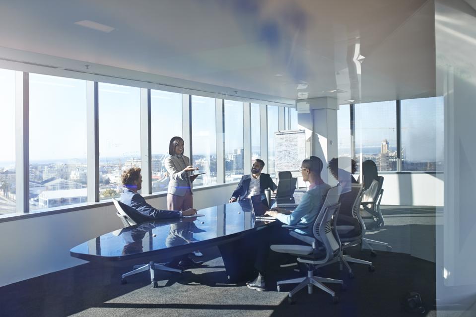 Young entrepreneur presenting project in exclusive boardroom