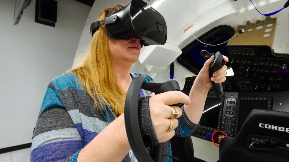 Boeing will use Finland-based Varjo’s VR-2 virtual reality devices to simulate the control panels and interior design of Starliner capsules. Image shows Connie Miller with Varjo headset.