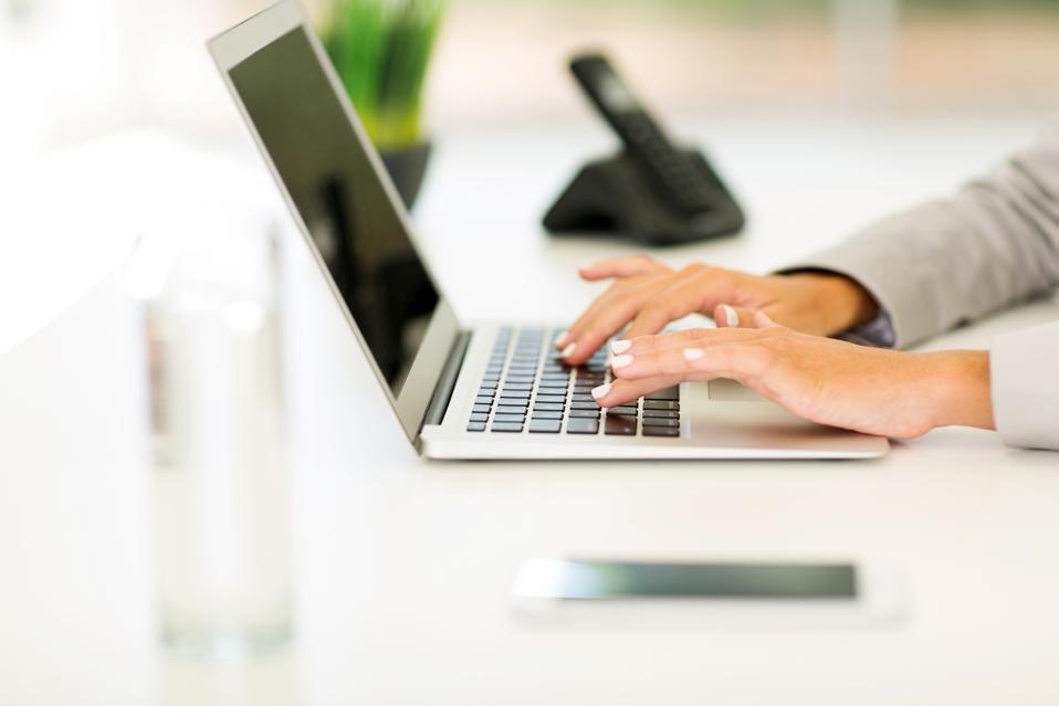 Woman working on computer. How A Truly Great Business Needs Only $100 To Open Shop