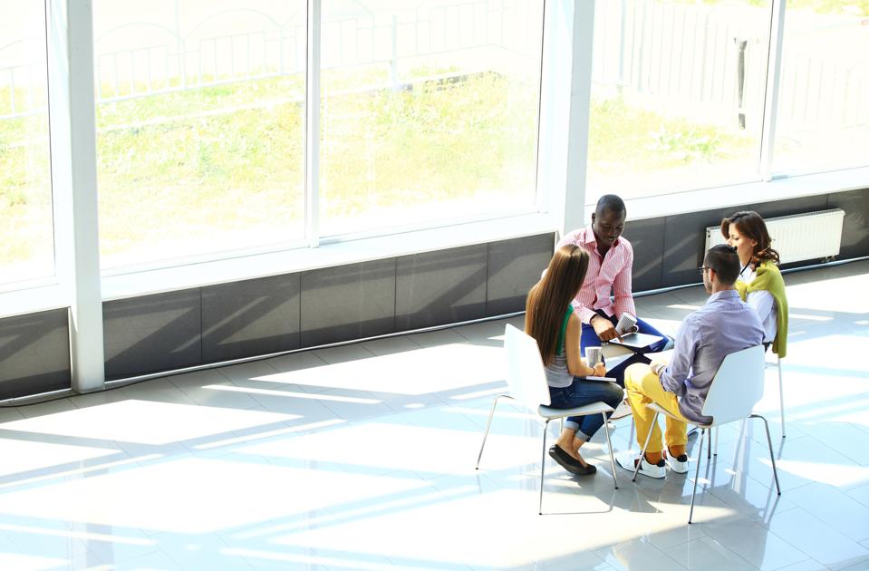 4 people meeting What Business In A Post-Pandemic Economy Looks Like | Stephanie Burns
