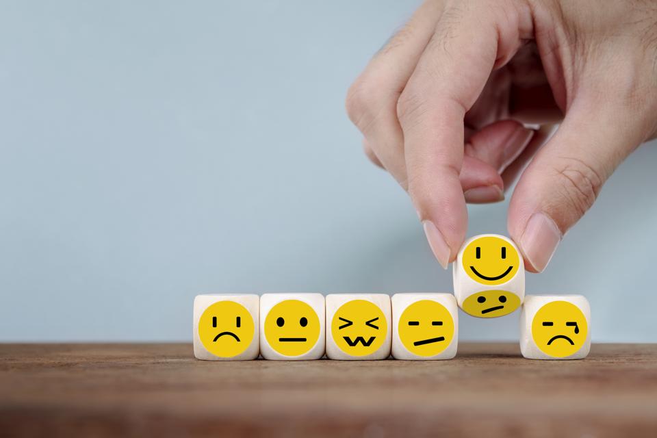 Hand Changing with smile emoticon icons face on Wooden Cube, hand flipping unhappy turning to happy symbol