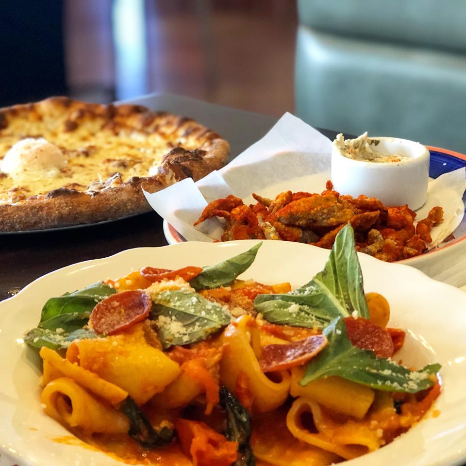 Paccheri Arrabbiata with spicy Ezzo pepperoni; Fried Smelts with sweet chili and tartar sauce; and Carbonara Pizza with smoked pancetta and poached egg at Mad Bene on Oahu.