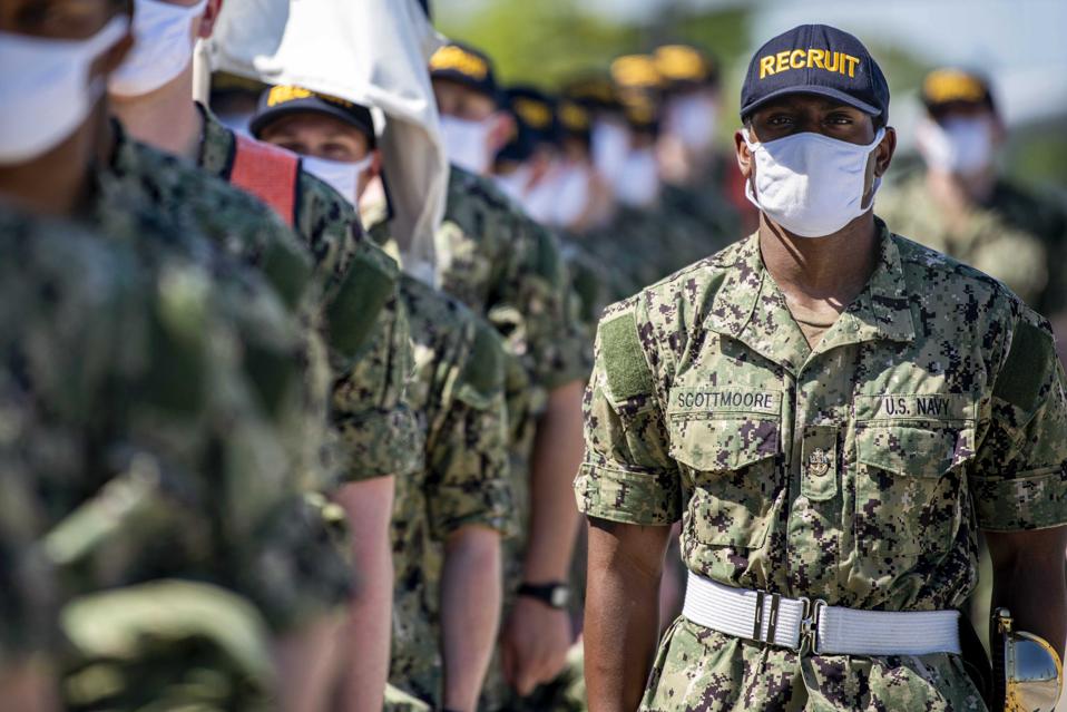 Navy recruits in formation wearing protective masks.