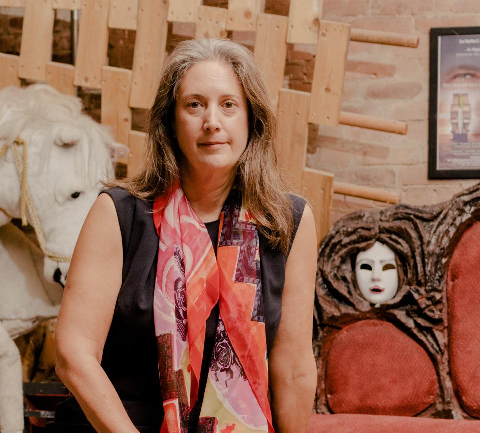 Laura Callanan seated at LaMaMa Archives.The Ellen Stewart Private Collection