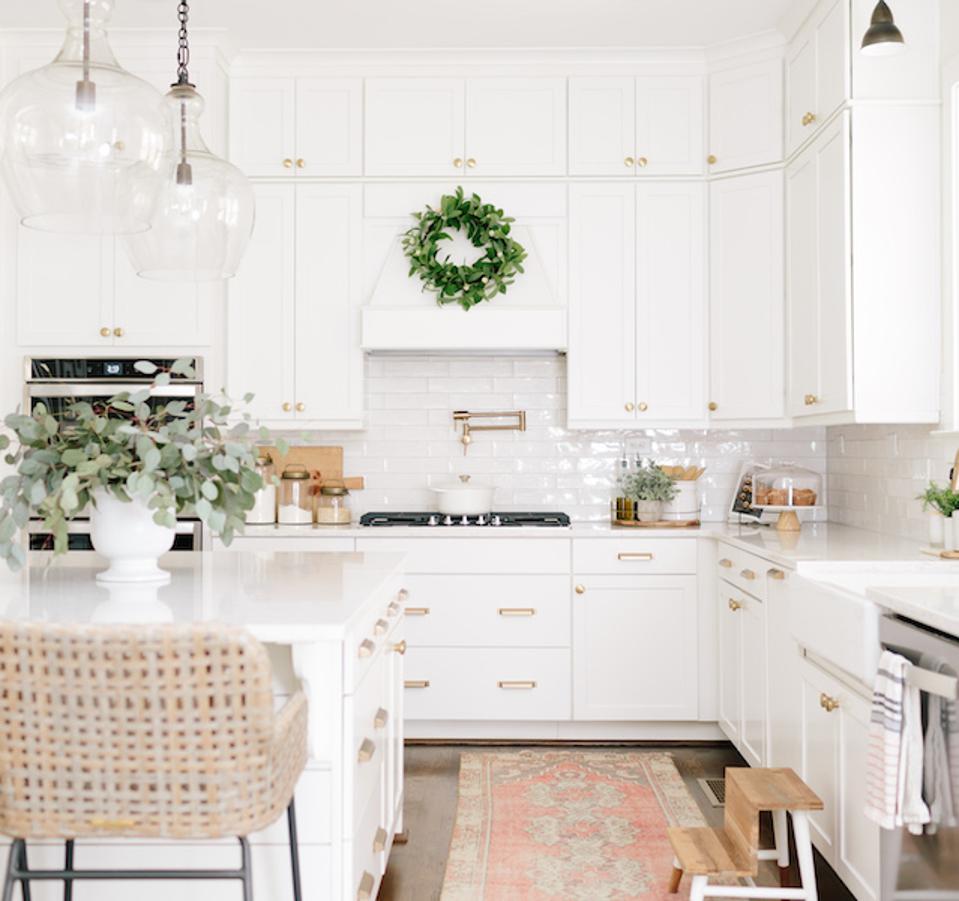 A kitchen with gold hardware 