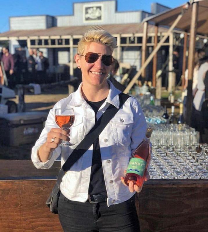 Winemaker Rae Wilson with bottle and glass of wine